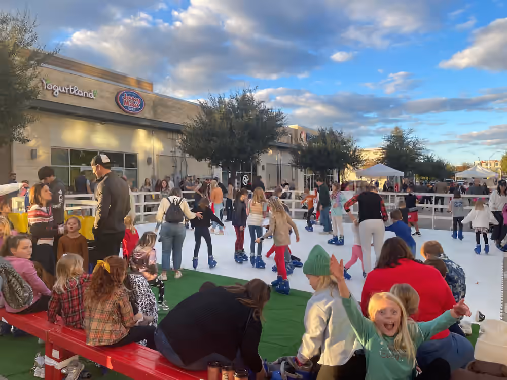 Families skating together at a daytime Classic Holiday rink