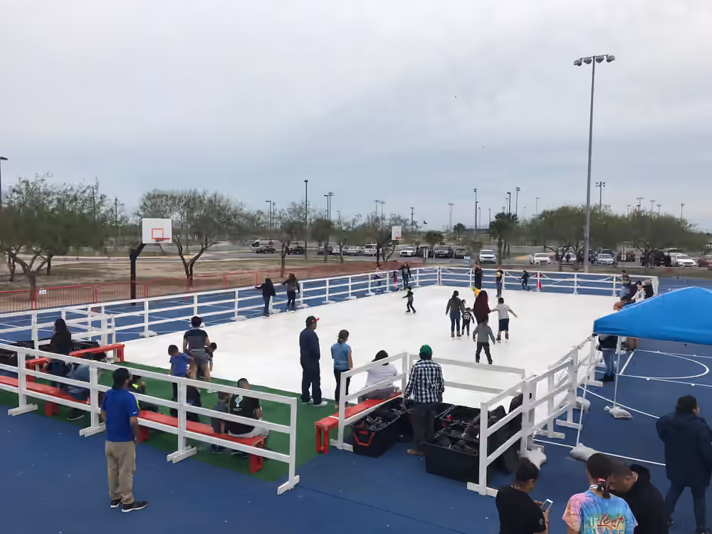 A large portable rink surrounded by guests