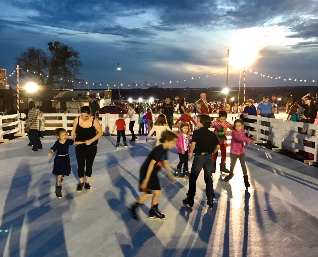 Families skating at an authentic Classic Holiday evening event