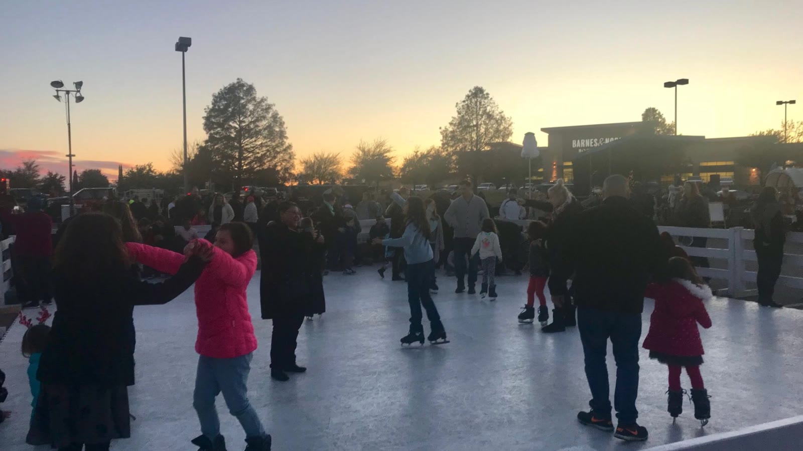 Guests skating on a Classic Holiday portable synthetic ice rink